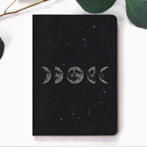 Pack of two small mini notebooks showing the phases of the moon against a starry space background.