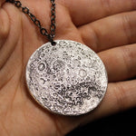 Fine silver double-sided supermoon full moon coin pendant necklace - the perfect moon gift! Showing far side of the Moon with black chain.