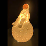 Porcelain space decor lamp of an astronaut sitting on the moon!