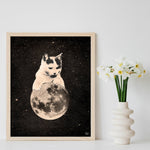 8x10" cat and moon in space art print, shown in frame with flowers